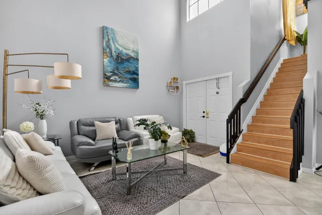 a living room with furniture and stairs