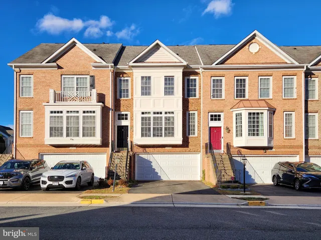 a front view of a house with a parking space