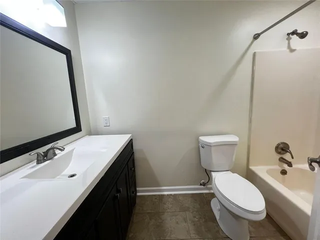 a bathroom with a sink a toilet and mirror