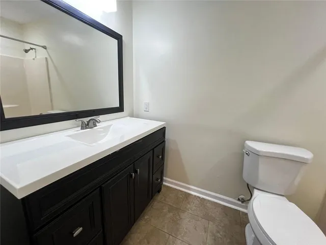 a bathroom with a sink mirror vanity and toilet