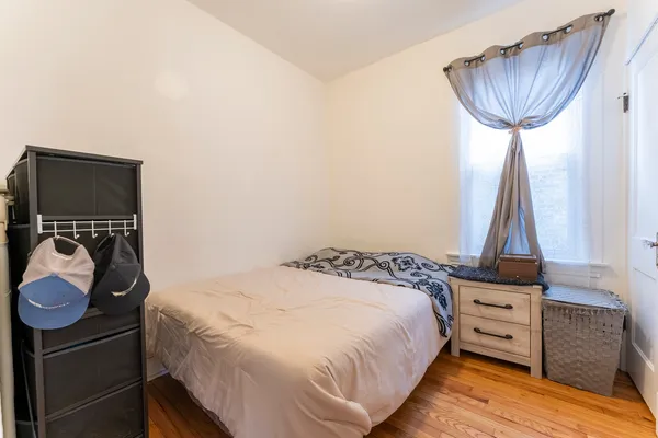 a bedroom with a bed and a dresser