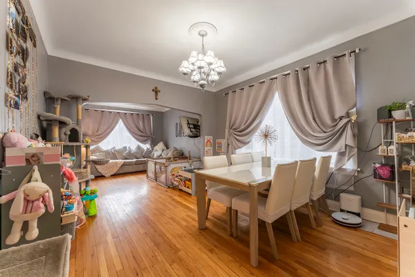 a living room with furniture a fireplace and a chandelier
