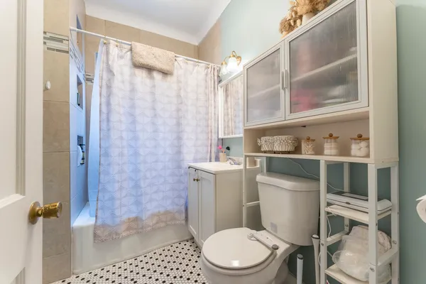 a bathroom with a toilet and a shower