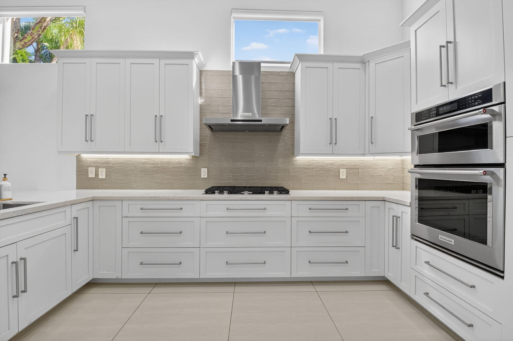 6270 Northwest 43rd Terrace Boca Raton, FL 33496 - Photo 13 of 27 a kitchen with granite countertop white cabinets stainless steel appliances and a sink