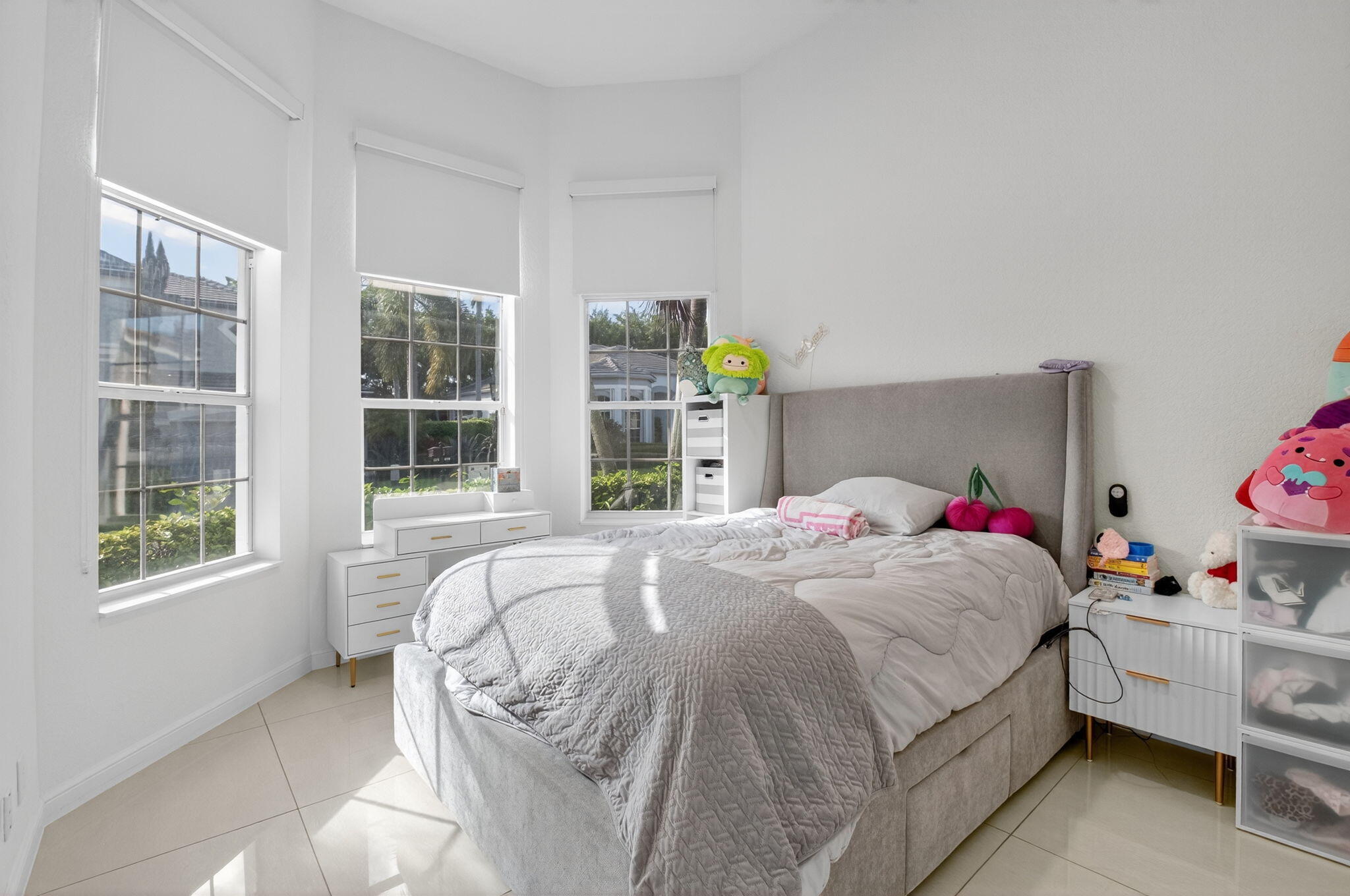 6270 Northwest 43rd Terrace Boca Raton, FL 33496 - Photo 22 of 27 a bedroom with a bed a window and dresser