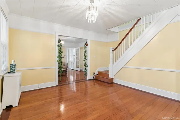 a view of an entryway with wooden floor