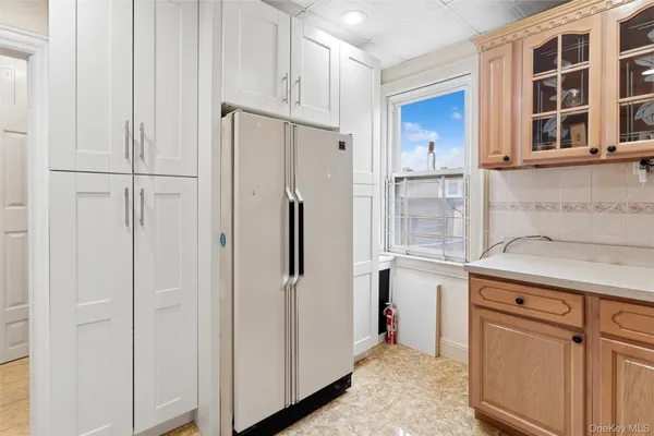 a kitchen with cabinets and a refrigerator
