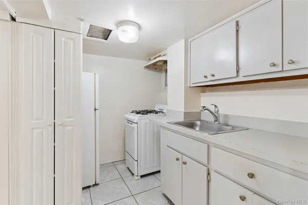 a bathroom with a sink mirror and shower
