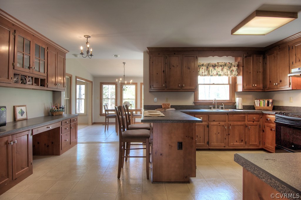 4602 Twin Cedars Road Chester, VA 23831 - Photo 11 of 47 a open kitchen with granite countertop a stove top oven a sink dishwasher and cabinets with wooden floor