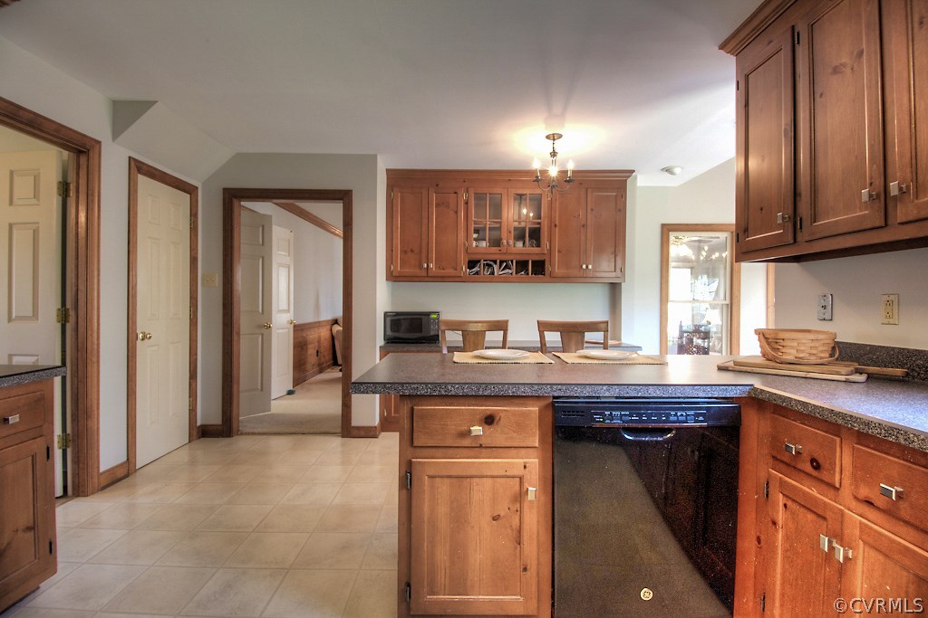4602 Twin Cedars Road Chester, VA 23831 - Photo 12 of 47 a kitchen with stainless steel appliances granite countertop a stove a sink and a refrigerator with wooden cabinets