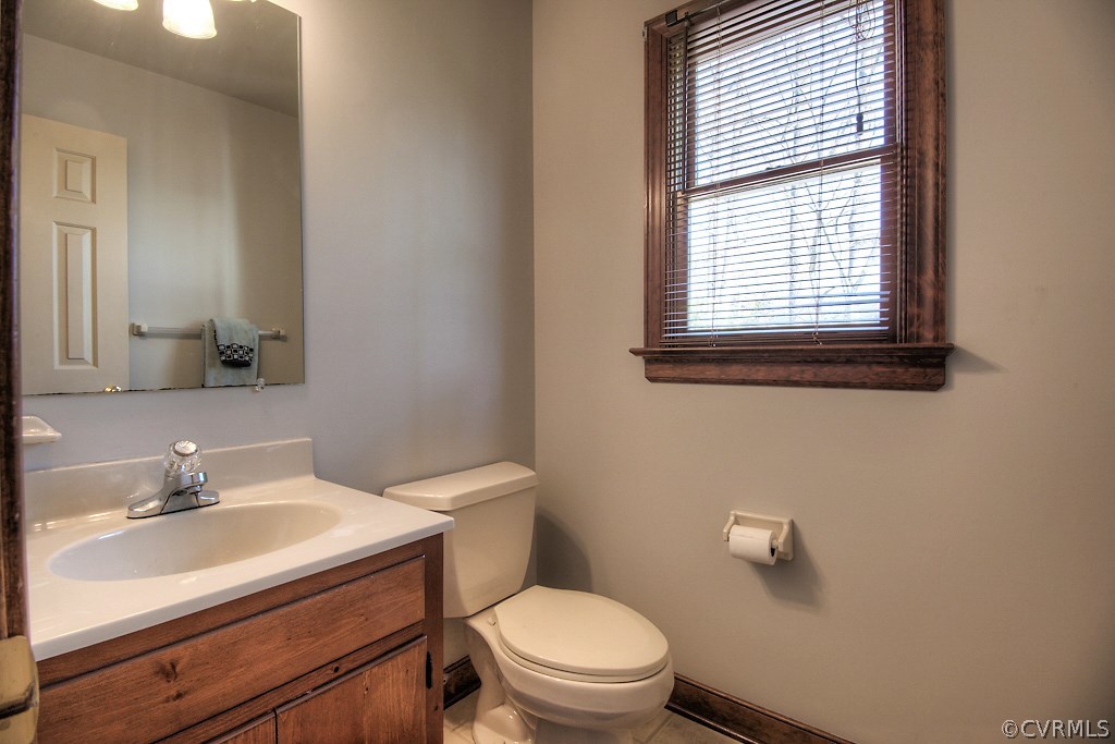 4602 Twin Cedars Road Chester, VA 23831 - Photo 22 of 47 a bathroom with a sink a toilet and a mirror