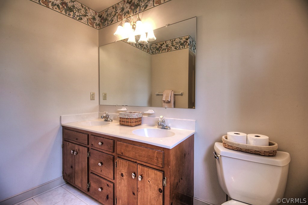 4602 Twin Cedars Road Chester, VA 23831 - Photo 27 of 47 a bathroom with a toilet sink and mirror