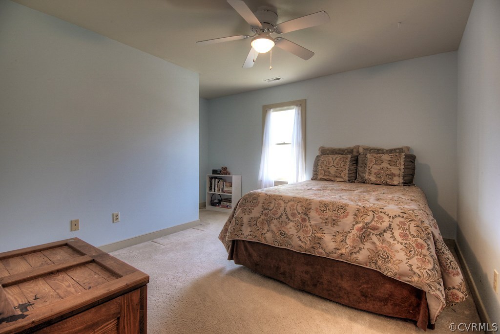 4602 Twin Cedars Road Chester, VA 23831 - Photo 33 of 47 a bedroom with a bed and a chandelier