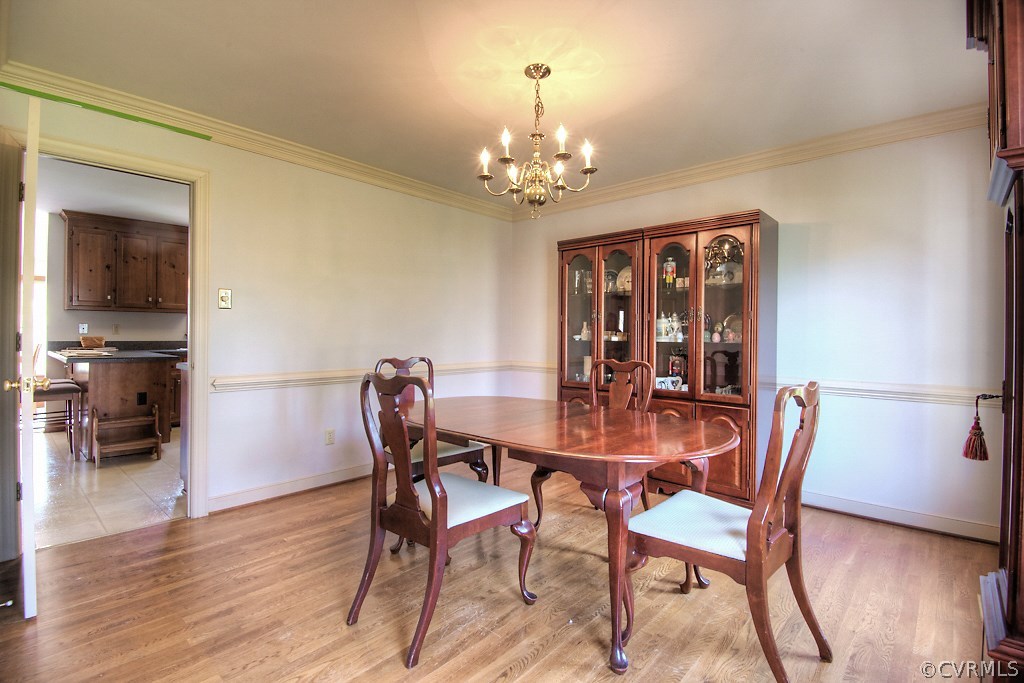 4602 Twin Cedars Road Chester, VA 23831 - Photo 8 of 47 a view of a dining room with furniture and wooden floor