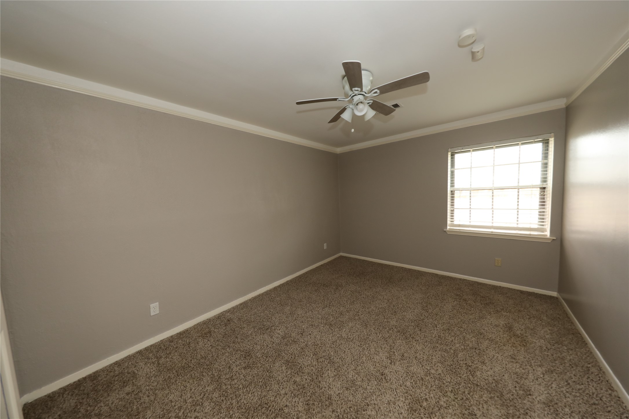 8519 Leader Street Houston, TX 77036 - Photo 11 of 27 an empty room with a window and a fan