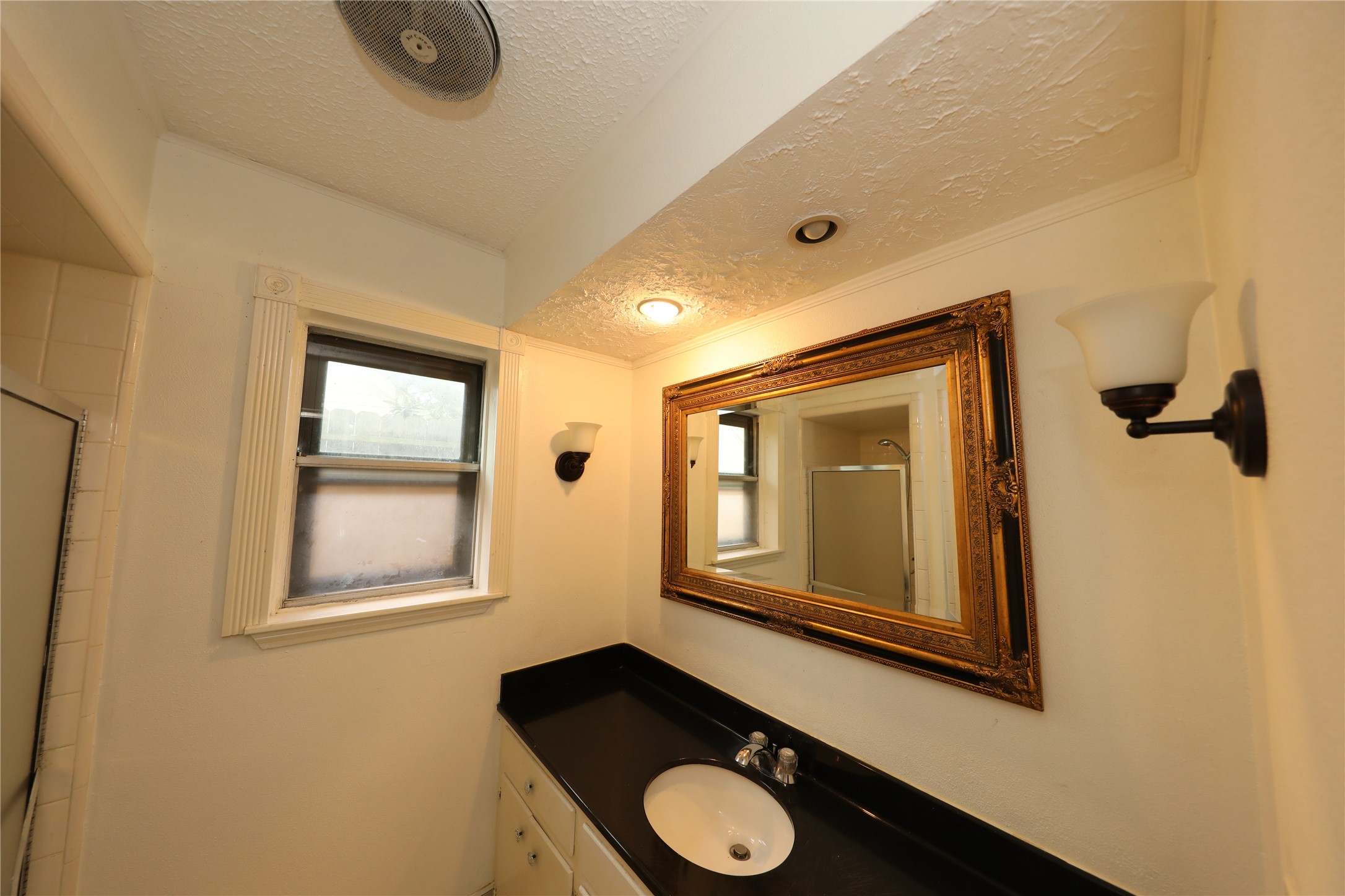 8519 Leader Street Houston, TX 77036 - Photo 12 of 27 a bathroom with a sink mirror vanity and window