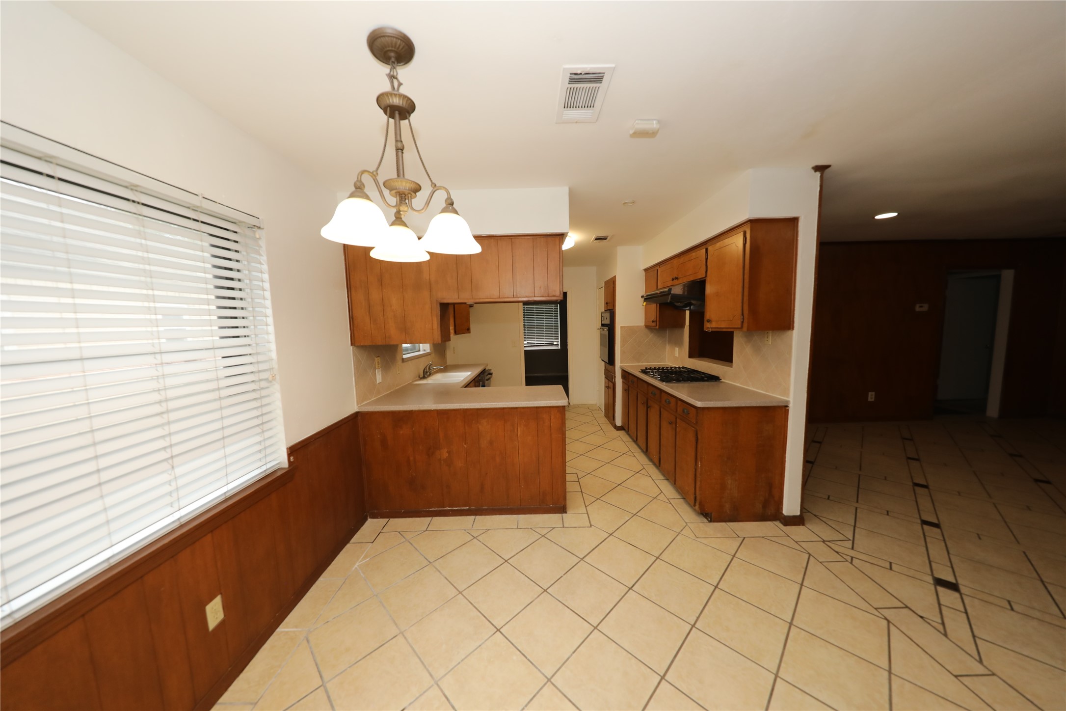 8519 Leader Street Houston, TX 77036 - Photo 16 of 27 a kitchen with stainless steel appliances kitchen island granite countertop a sink and cabinets