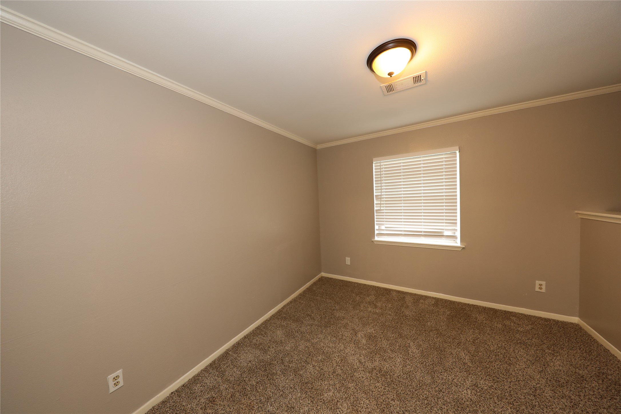 8519 Leader Street Houston, TX 77036 - Photo 3 of 27 a view of room with a ceiling fan and window