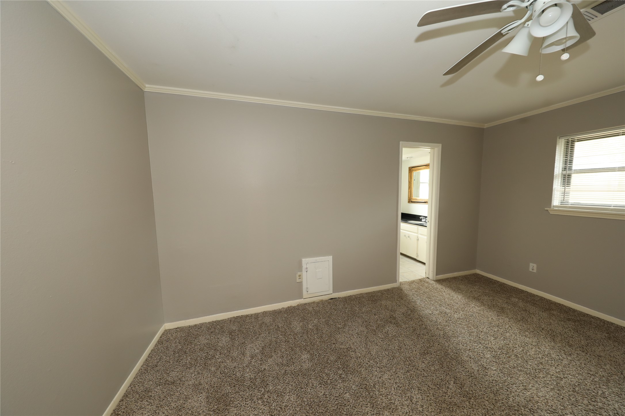 8519 Leader Street Houston, TX 77036 - Photo 6 of 27 an empty room with windows and fan