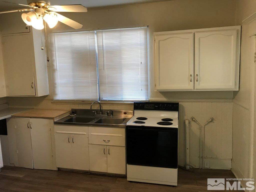 522 Roberts Street Reno, NV 89502 - Photo 8 of 39 a kitchen with stainless steel appliances granite countertop a sink a stove and a microwave