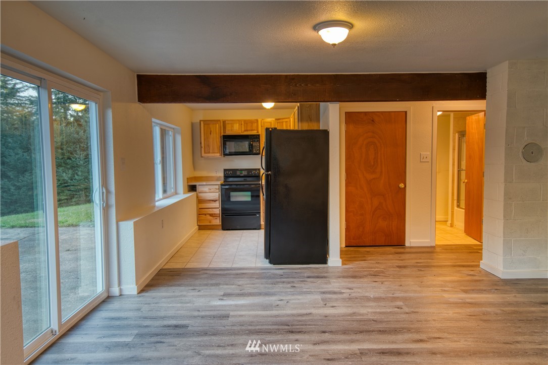183 # 12 Spooner Road Chehalis, WA 98532 - Photo 12 of 21 a view of a refrigerator in kitchen and wooden floor