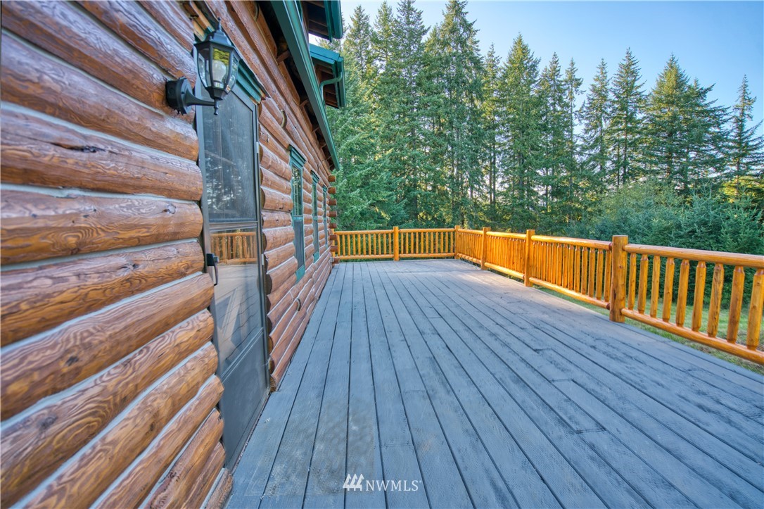 183 # 12 Spooner Road Chehalis, WA 98532 - Photo 14 of 21 a balcony with wooden floor and trees in the back