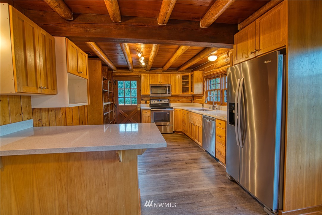 183 # 12 Spooner Road Chehalis, WA 98532 - Photo 5 of 21 a kitchen with stainless steel appliances granite countertop a refrigerator a sink dishwasher a stove and a microwave oven with cabinets