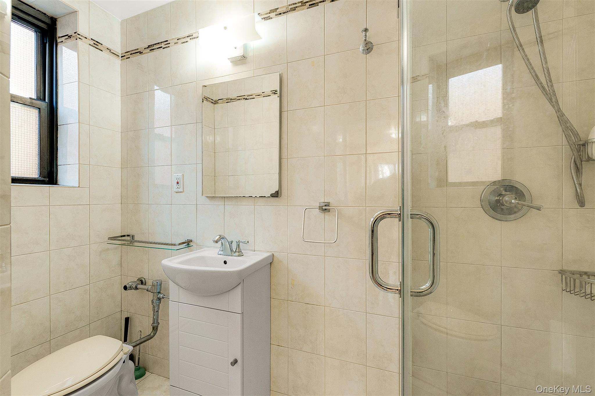 109-23 71st Road Queens, NY 11375 - Photo 20 of 21 a bathroom with a sink a toilet and shower