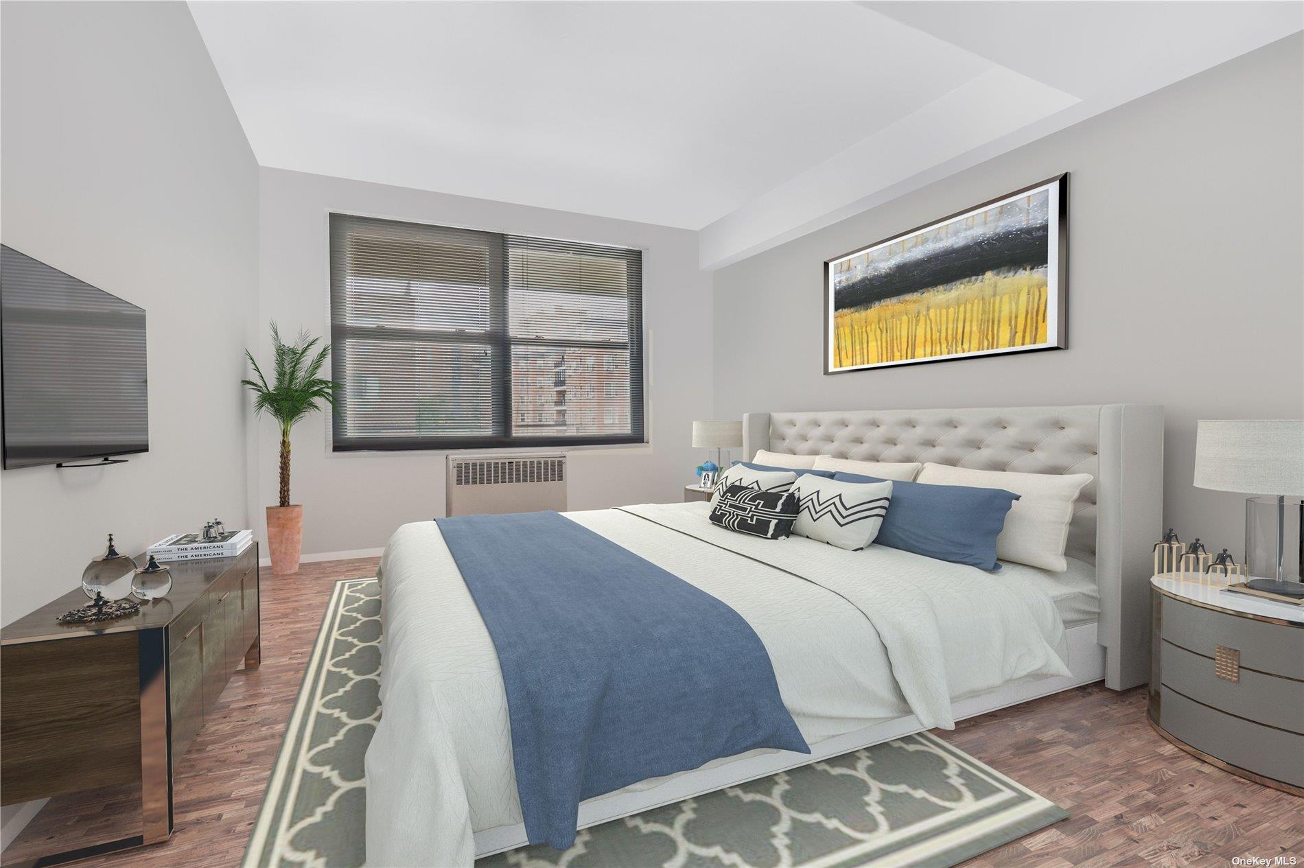 98-22 63rd Drive, Unit 5E Queens, NY 11374 - Photo 12 of 15 a bedroom with bed and a flat tv screen on dresser