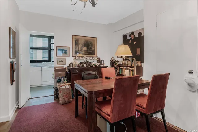 a view of a dining room with furniture and a chandelier