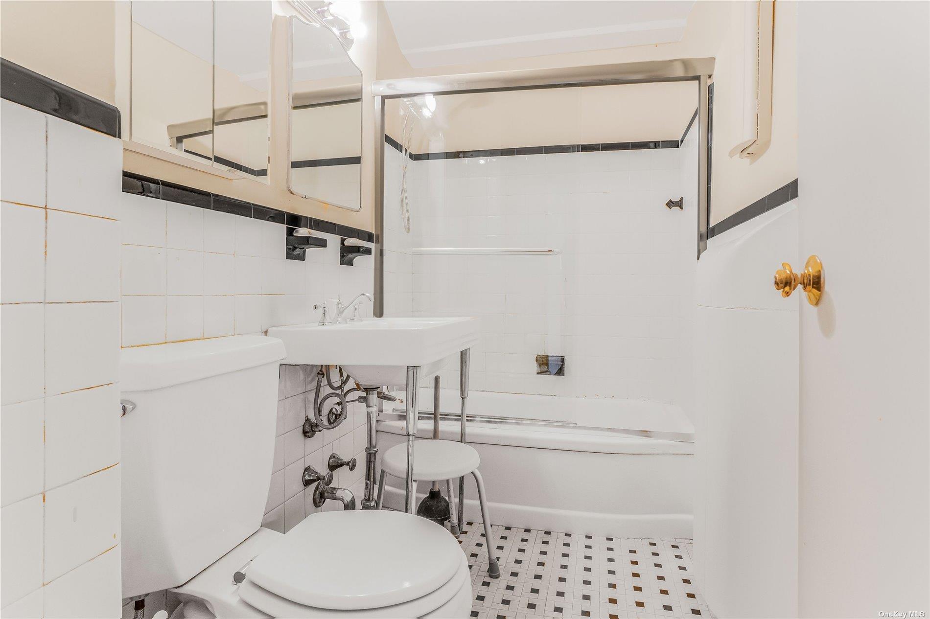 98-22 63rd Drive, Unit 5E Queens, NY 11374 - Photo 9 of 15 a bathroom with a sink a toilet and shower