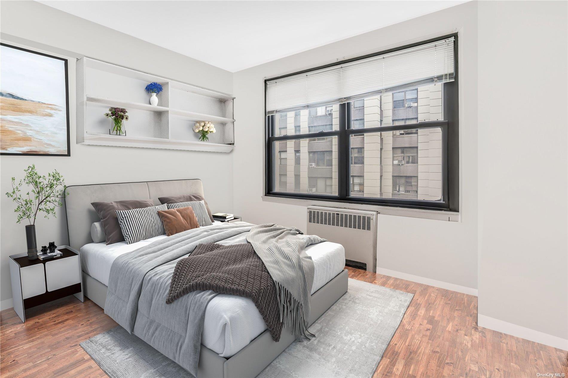 98-22 63rd Drive, Unit 5E Queens, NY 11374 - Photo 10 of 15 a bedroom with a bed and a large window