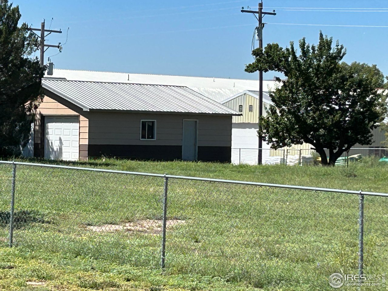 207 Dickson Street Wiggins, CO 80654 - Photo 1 of 9 a front view of a house with garden