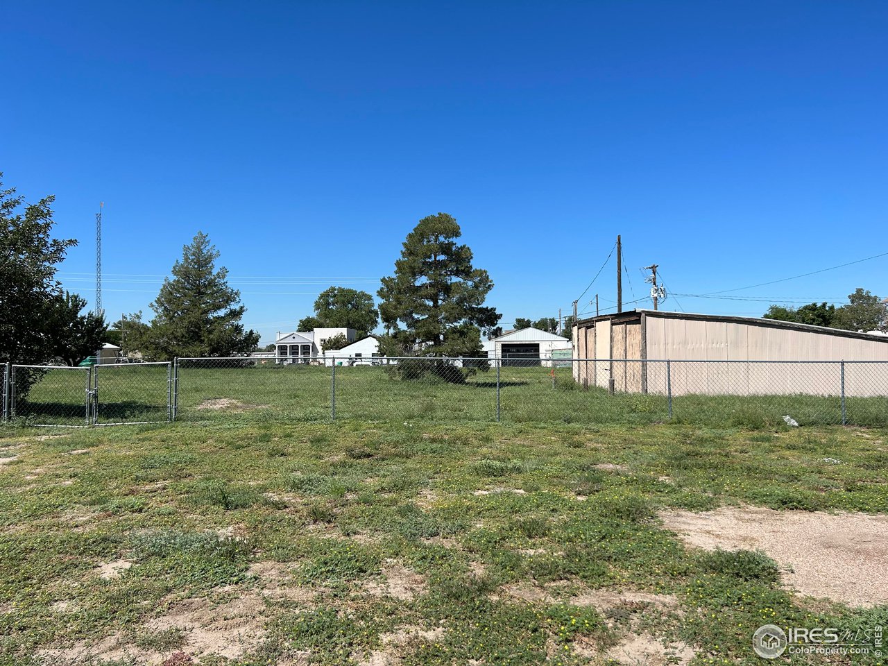 207 Dickson Street Wiggins, CO 80654 - Photo 6 of 9 a backyard of a house with lots of green space