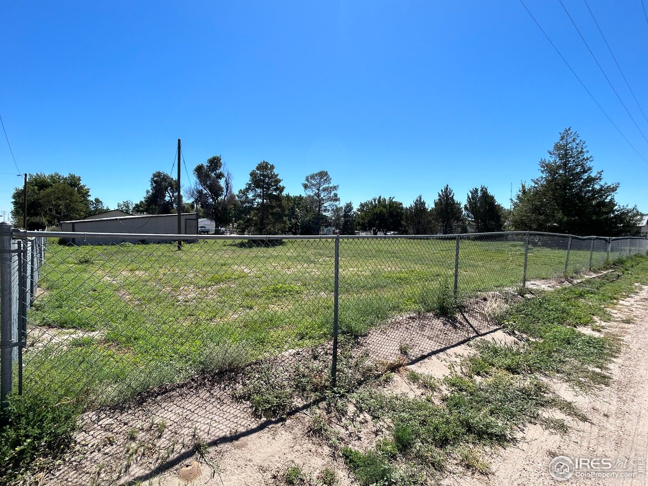 207 Dickson Street Wiggins, CO 80654 - Photo 9 of 9 a view of a golf course with a lake