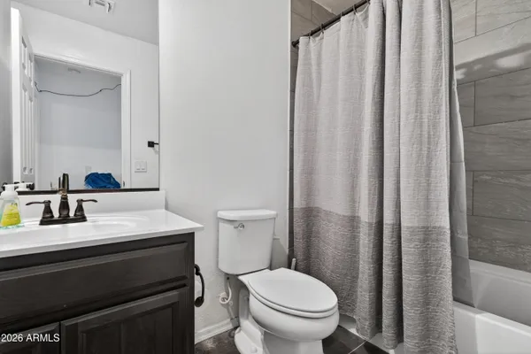 a spacious bedroom with a bed and a chandelier
