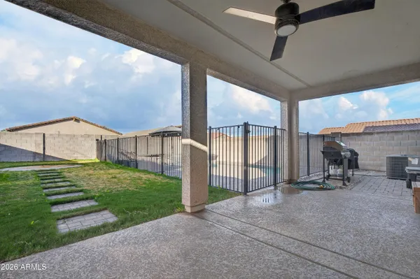 a view of a house with backyard and sitting area