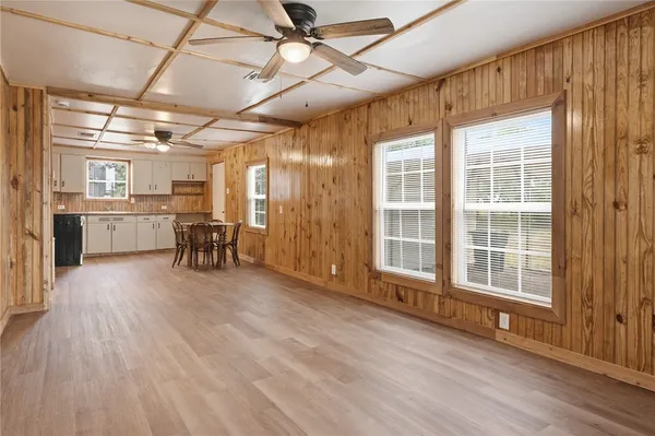 a view of a livingroom with furniture wooden floor and a window