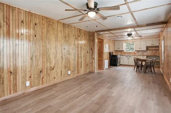 a view of a livingroom with furniture wooden floor and fan