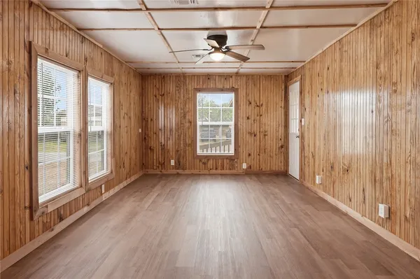 a view of a room with wooden floor and windows