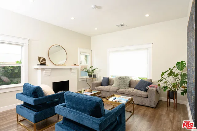 a living room with furniture a fireplace with wooden floor