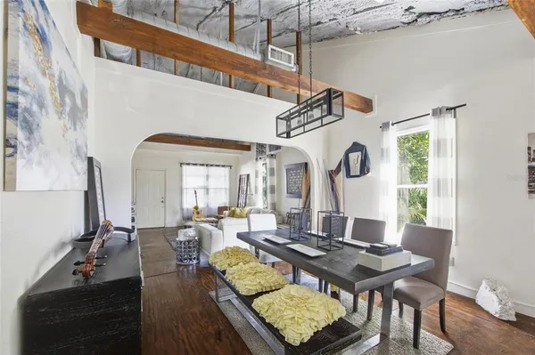 a living room with furniture a rug and a window