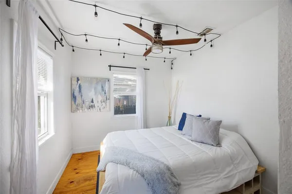 a bedroom with a bed and a window
