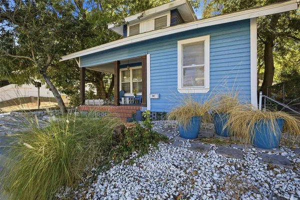 a view of a house with backyard and sitting area