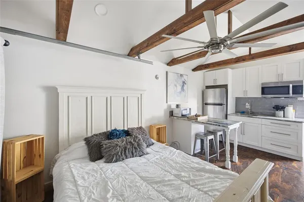 a bedroom with a bed a table and chairs