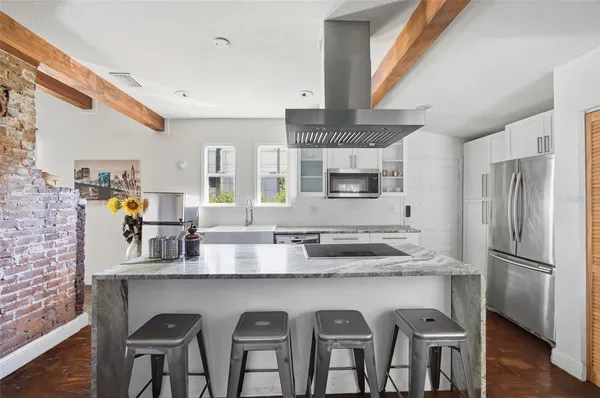 a kitchen with stainless steel appliances granite countertop a sink and a refrigerator