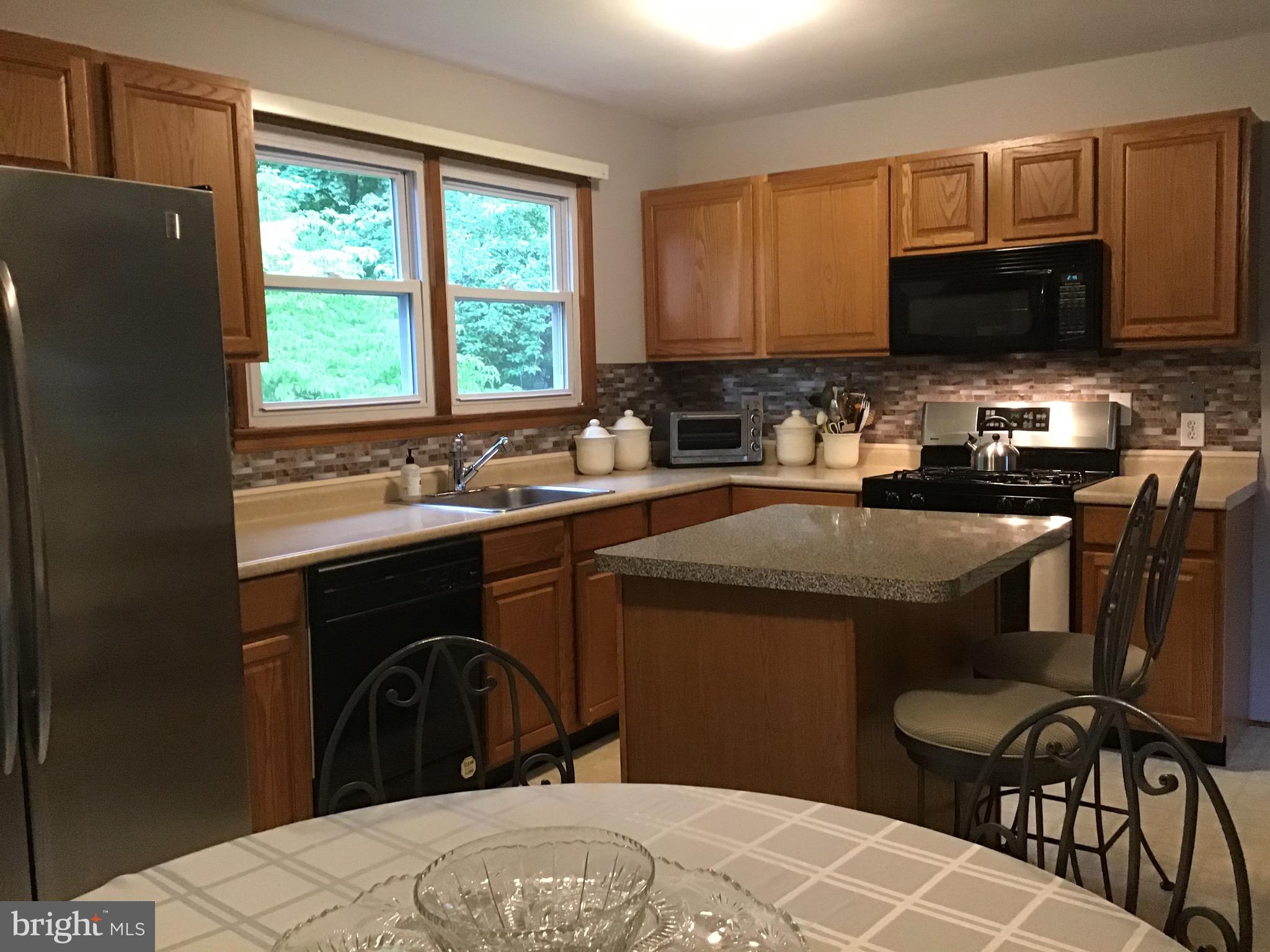 1503 Marshall Mill Road Franklinville, NJ 08322 - Photo 7 of 34 a kitchen with a sink a stove a microwave a refrigerator and cabinets