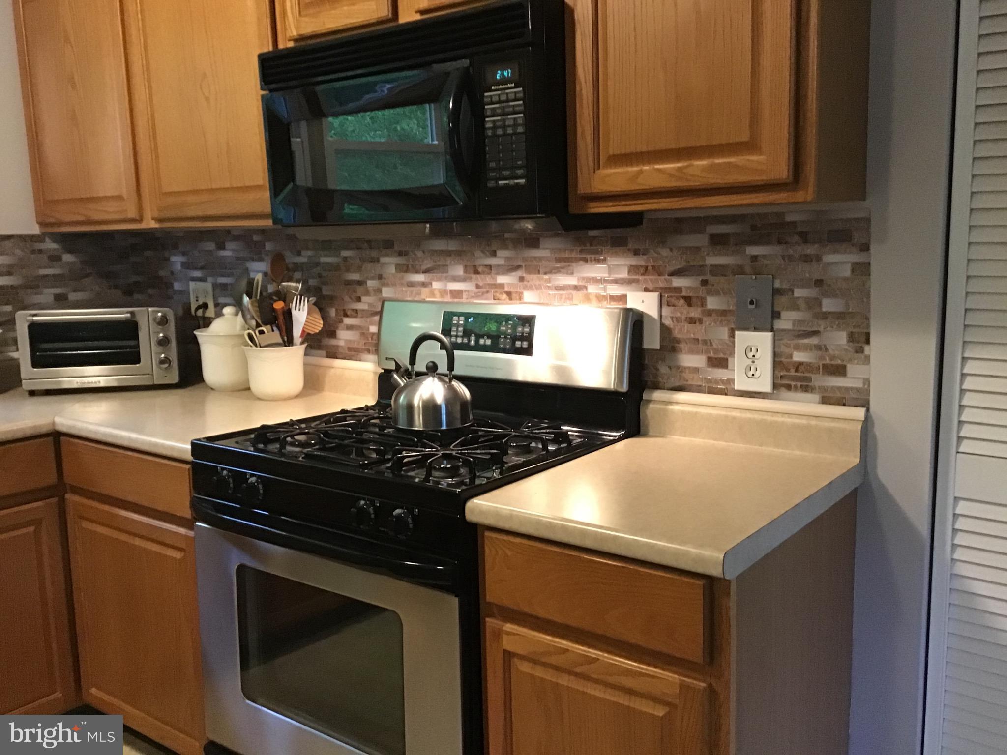 1503 Marshall Mill Road Franklinville, NJ 08322 - Photo 8 of 34 a kitchen with granite countertop a stove top oven a sink dishwasher and granite countertops with wooden floor