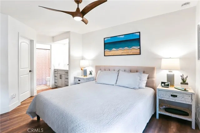 a bedroom with a bed and a night stand