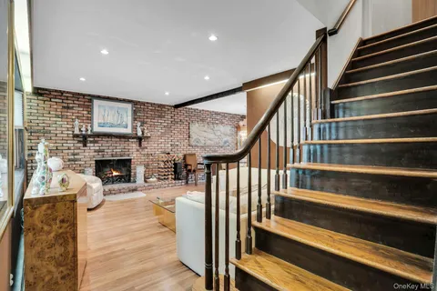 a living room with wooden floors and a fireplace